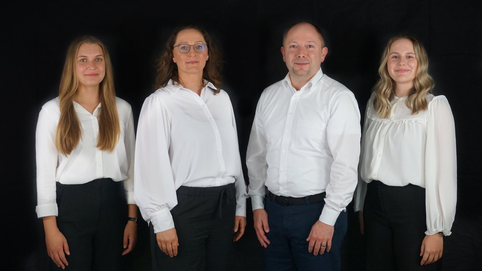 Gruppenfoto vor schwarzem Hintergrund